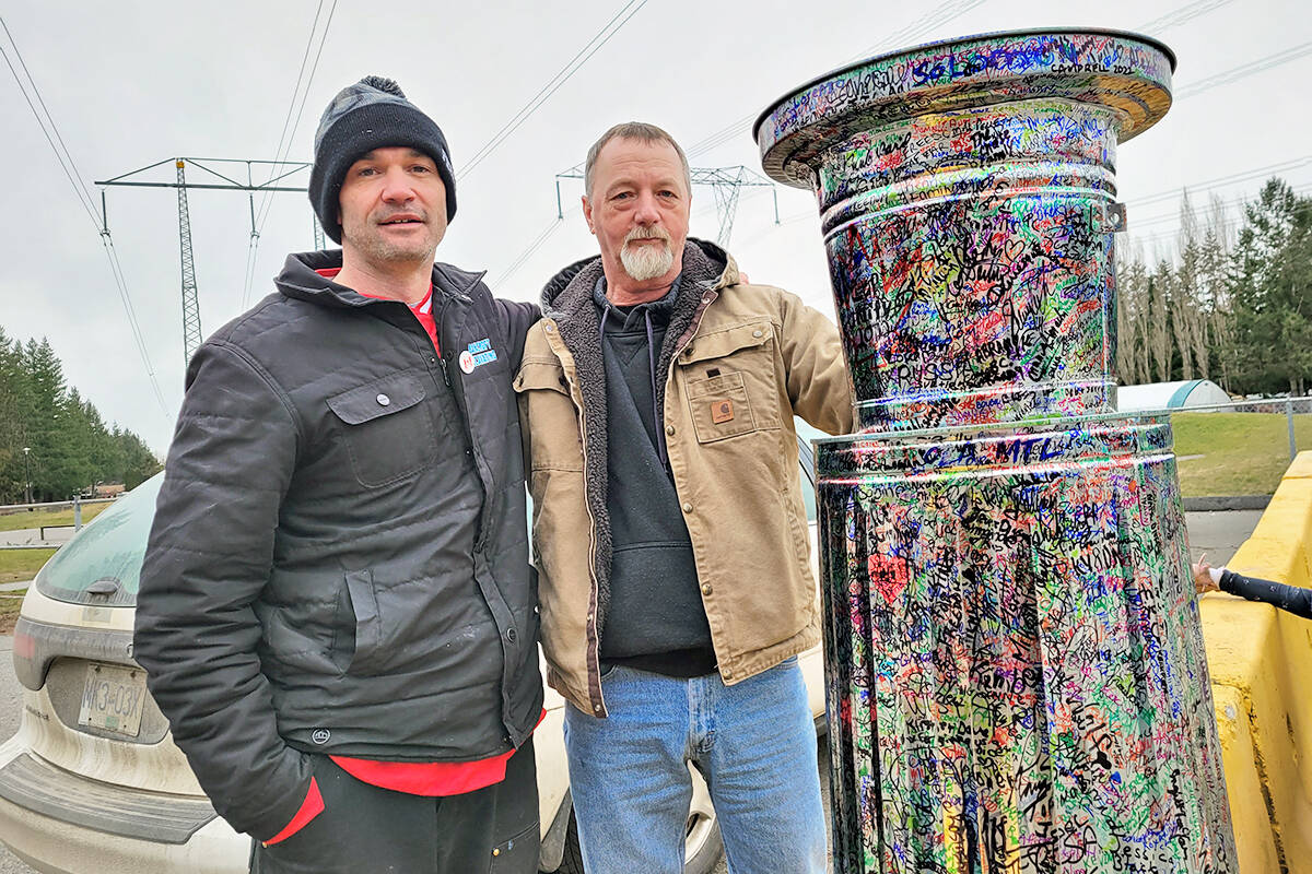 ‘Freedom convoy’ participant John Bancroft (left) and Al Fortin (right) who brought the “Unity Cup” from the Ottawa protest to a potluck barbecue and some parking lot hockey games for kids on Saturday, Feb. 26, at the George Preston rec centre. (Dan Ferguson/Langley Advance Times)
