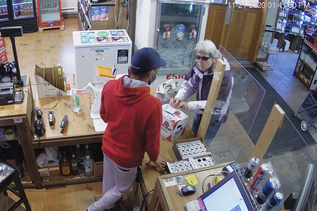 A still from a video released shows a woman who allegedly spat on an employee at Skaha Liquor Store and dropped his phone on the ground. (Facebook)