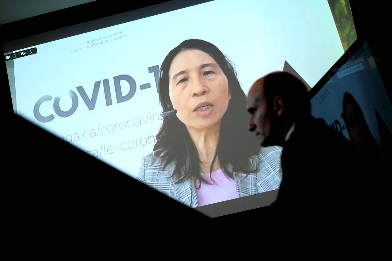 Chief Public Health Officer of Canada Dr. Theresa Tam is seen via videoconference as Minister of Health Jean-Yves Duclos looks on during a news conference on the COVID-19 pandemic and the omicron variant, in Ottawa, on Friday, Jan. 7, 2022. Tam says increased COVID-19 transmission is “not unexpected” as public health measures are lifted and cases pick up internationally. THE CANADIAN PRESS/Justin Tang