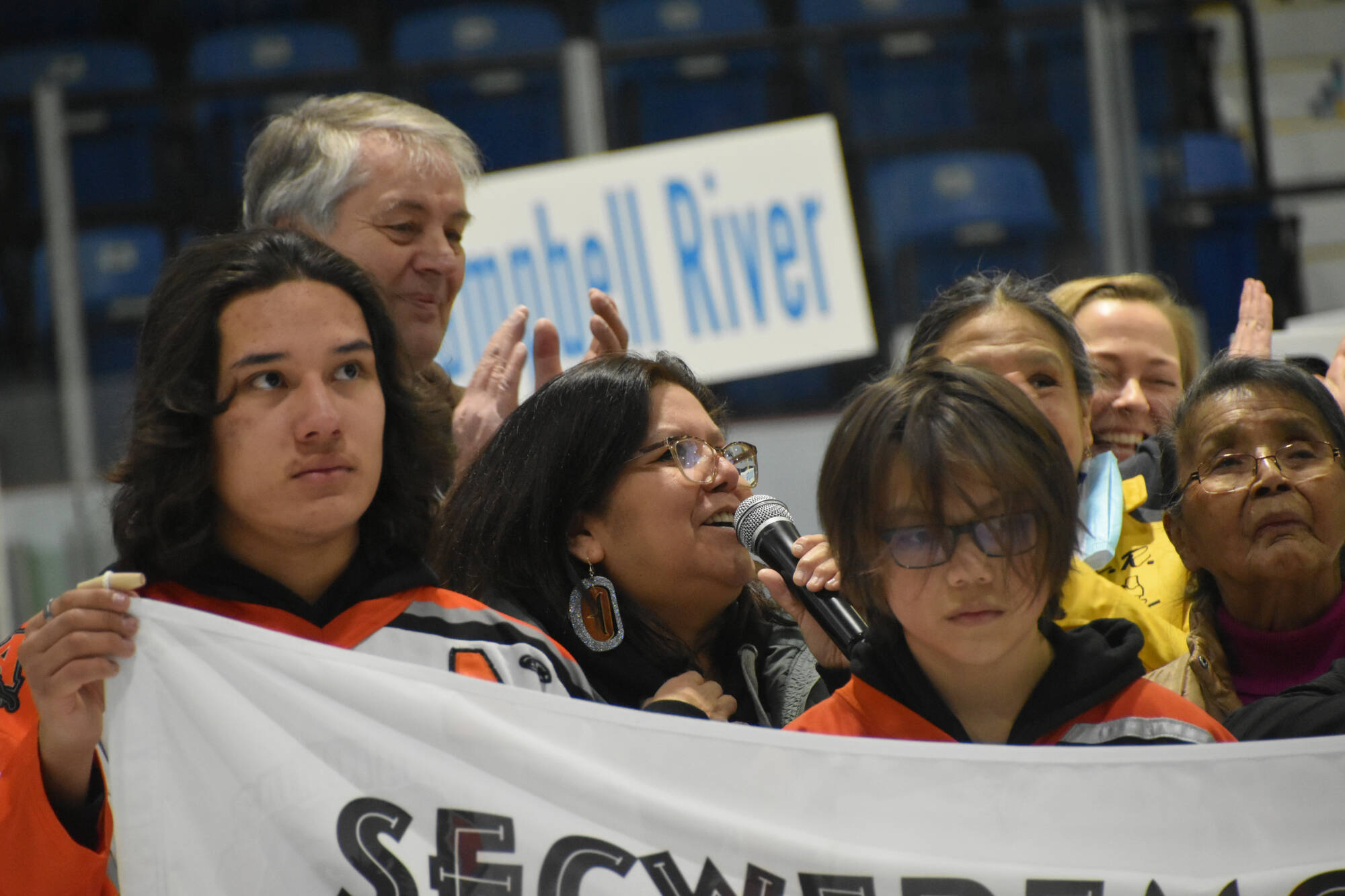 Adams Lake Band Kukpi7 (Chief) Lynn Kenoras-Duck Chief speaks to teams and supporters at the Shaw Centre’s Spectator Arena in Salmon Arm March 20 about the Secwépemc territory and flag, as it now hangs in place with the other flags in the arena. She and others spoke during the opening ceremonies of the BC Tier2 U13 championships running until March 23. (Martha Wickett - Salmon Arm Observer)