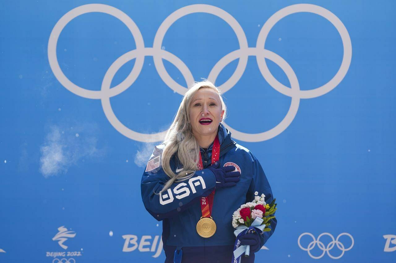 Kaillie Humphries, of the United States, sings the national anthem after winning the gold medal in the women’s monobob at the 2022 Winter Olympics, Monday, Feb. 14, 2022, in the Yanqing district of Beijing. Humphries had just become the first woman in history to win Olympic gold medals for two different countries. (AP Photo/Mark Schiefelbein)