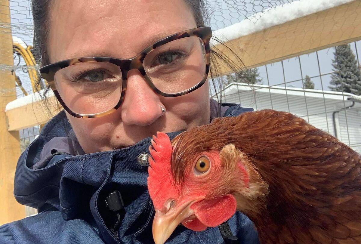 Cara with one of her four hens. (Image courtesy of Cara Dawn)