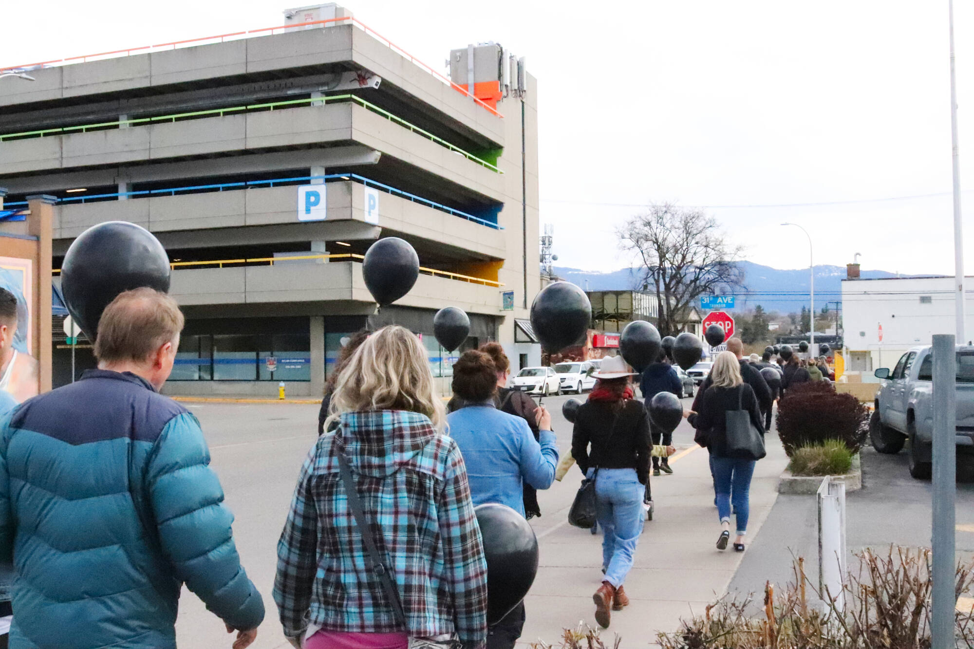 Members of the public walked through Vernon holding black balloons to raise awareness about overdoses and harm reduction on the sixth anniversary of B.C.’s declaration of the opioid crisis Thursday, April 14, 2022. (Brendan Shykora - Morning Star)