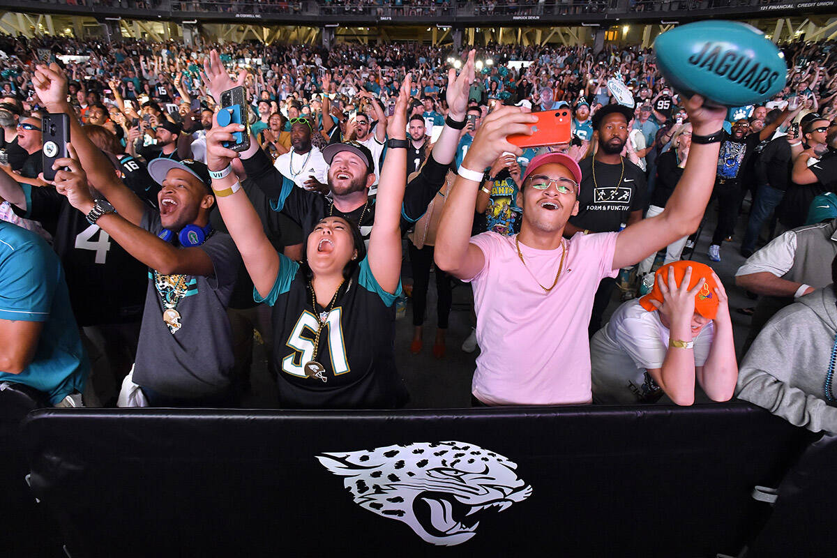 Jacksonville Jaguars fans celebrate as Georgia’s Travon Walker is announced as the team’s first pick No. 1 overall in the NFL football draft, during a draft party Thursday, April 28, 2022, in Jacksonville, Fla. (Bob Self/The Florida Times-Union via AP)