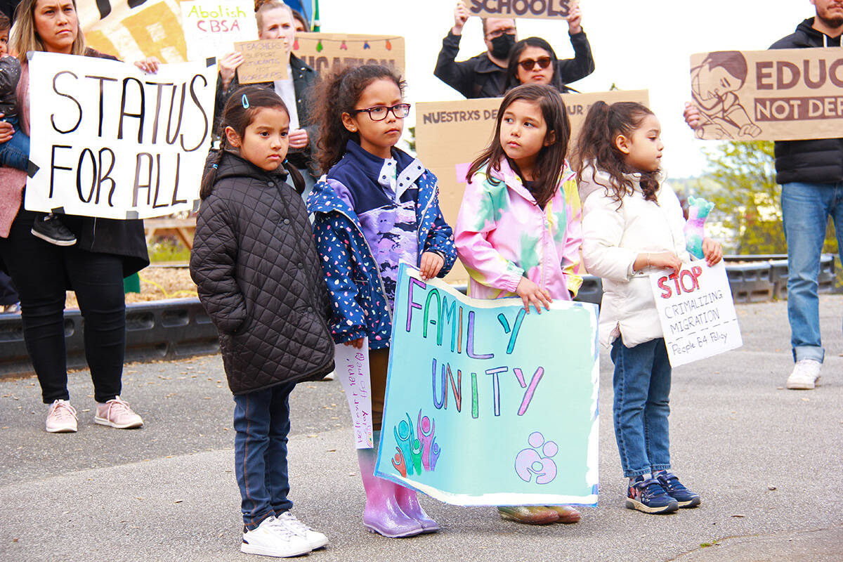 Dozens of New Westminster community members rallied outside Lord Tweedsmuir Elementary School May 9, calling for residency for a school family facing deportation to Mexico. (Jane Skrypnek/Black Press Media)