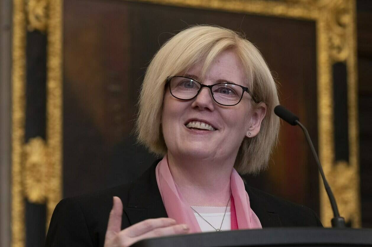 Employment, Workforce Development and Disability Inclusion Minister Carla Qualtrough smiles as she speaks to media after tabling a bill in the House of Commons Thursday, June 2, 2022 in Ottawa. THE CANADIAN PRESS/Adrian Wyld