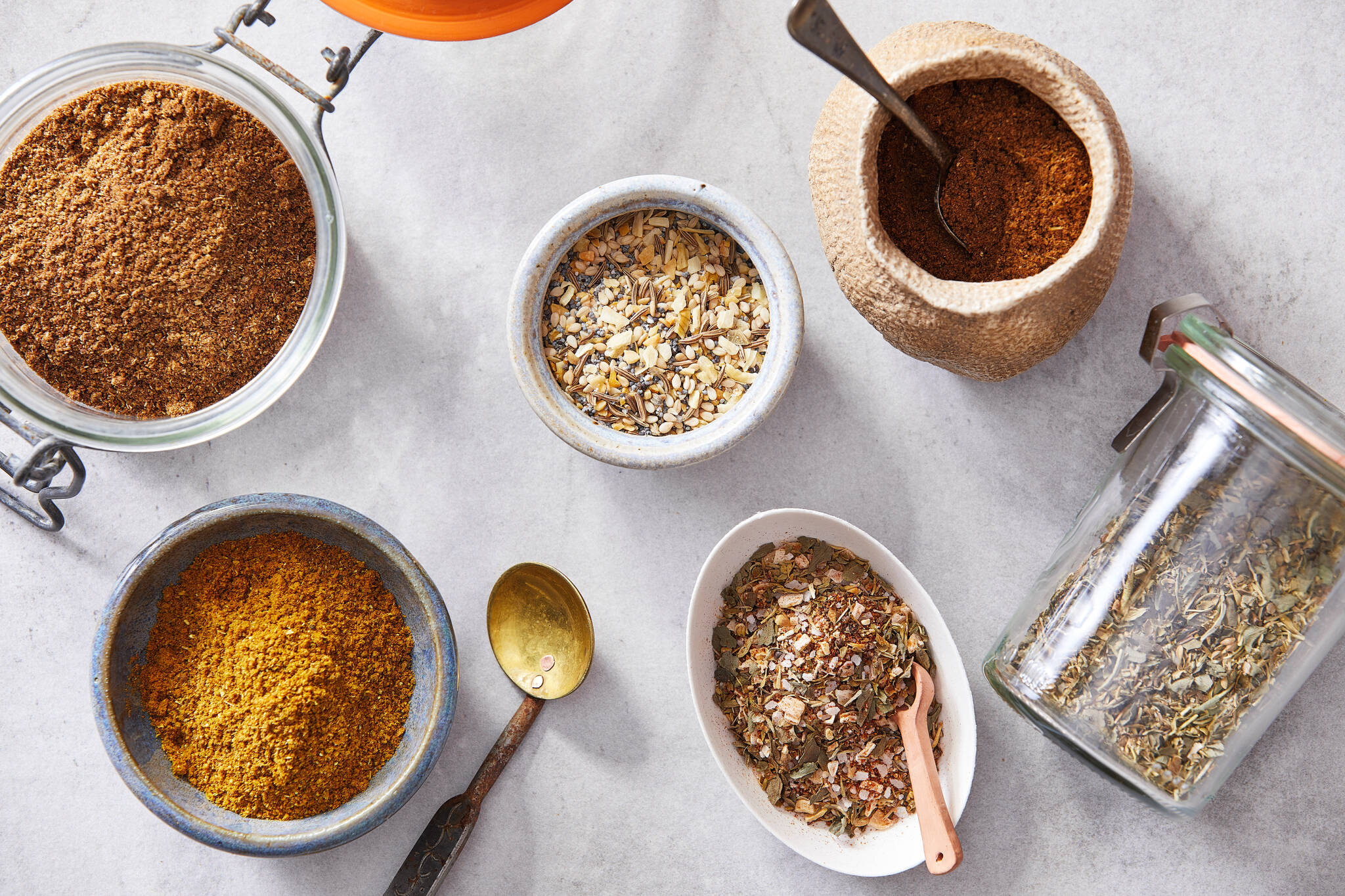 Clockwise from top left: five-spice powder, everything spice, garam masala, Italian seasoning, Cajun/Creole seasoning and ras el hanout. Friday, June 10, 2022 is Herbs and Spices Day. (Photo for The Washington Post by Tom McCorkle)