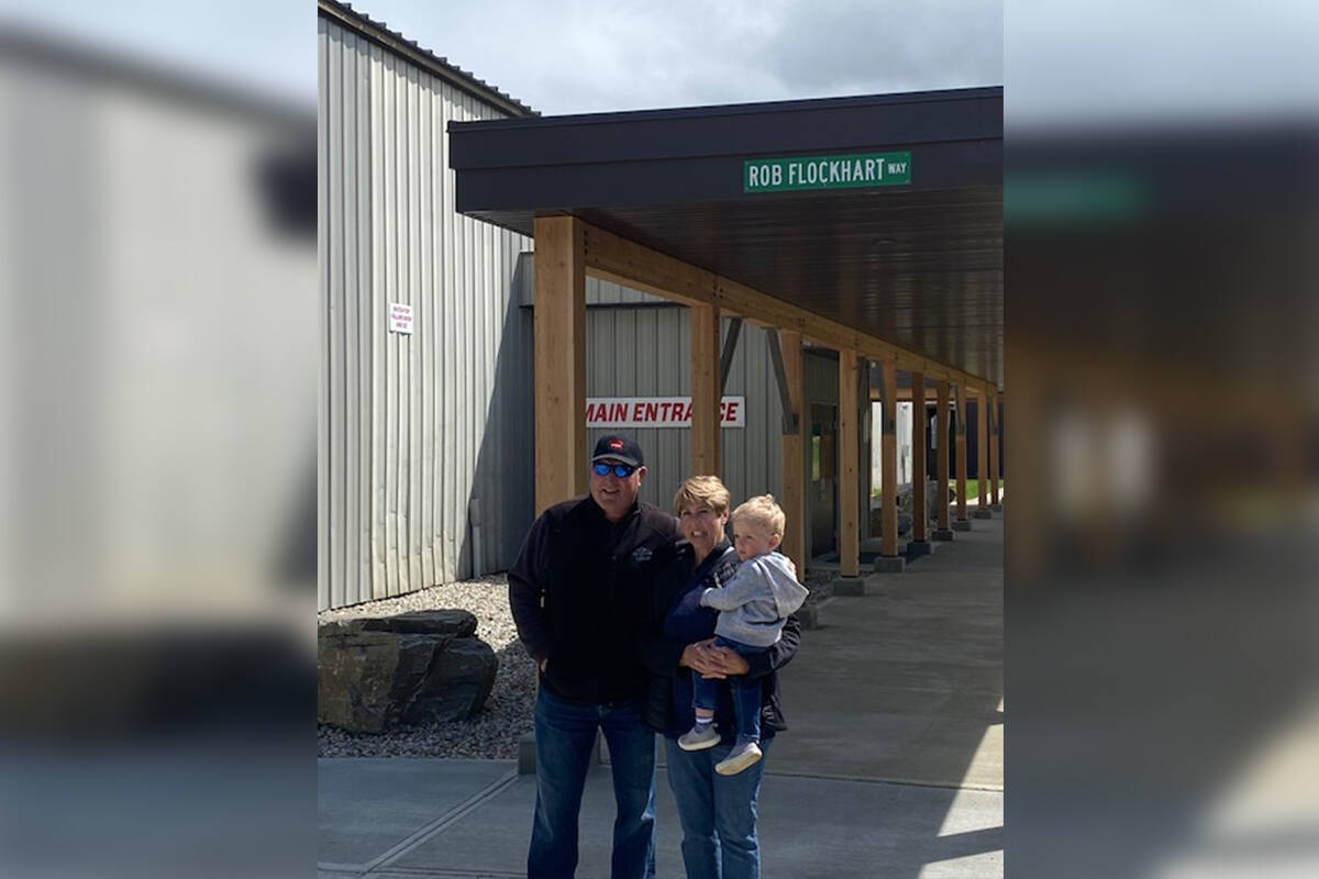 Ron Flockhart and sister LaVerne – holding her grandson, Conner – were at the Sicamous and District Recreation Centre for the unveiling of a sign honouring brother Rob Flockhart on June 6, 2021. (Contributed)