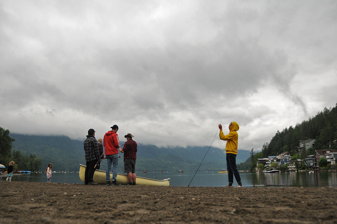 People get ready to hop into a canoe at Cultus Lake on Saturday, June 18, 2022. Sunday, June 26, 2022 is Canoe Day. (Jenna Hauck/ Chilliwack Progress)