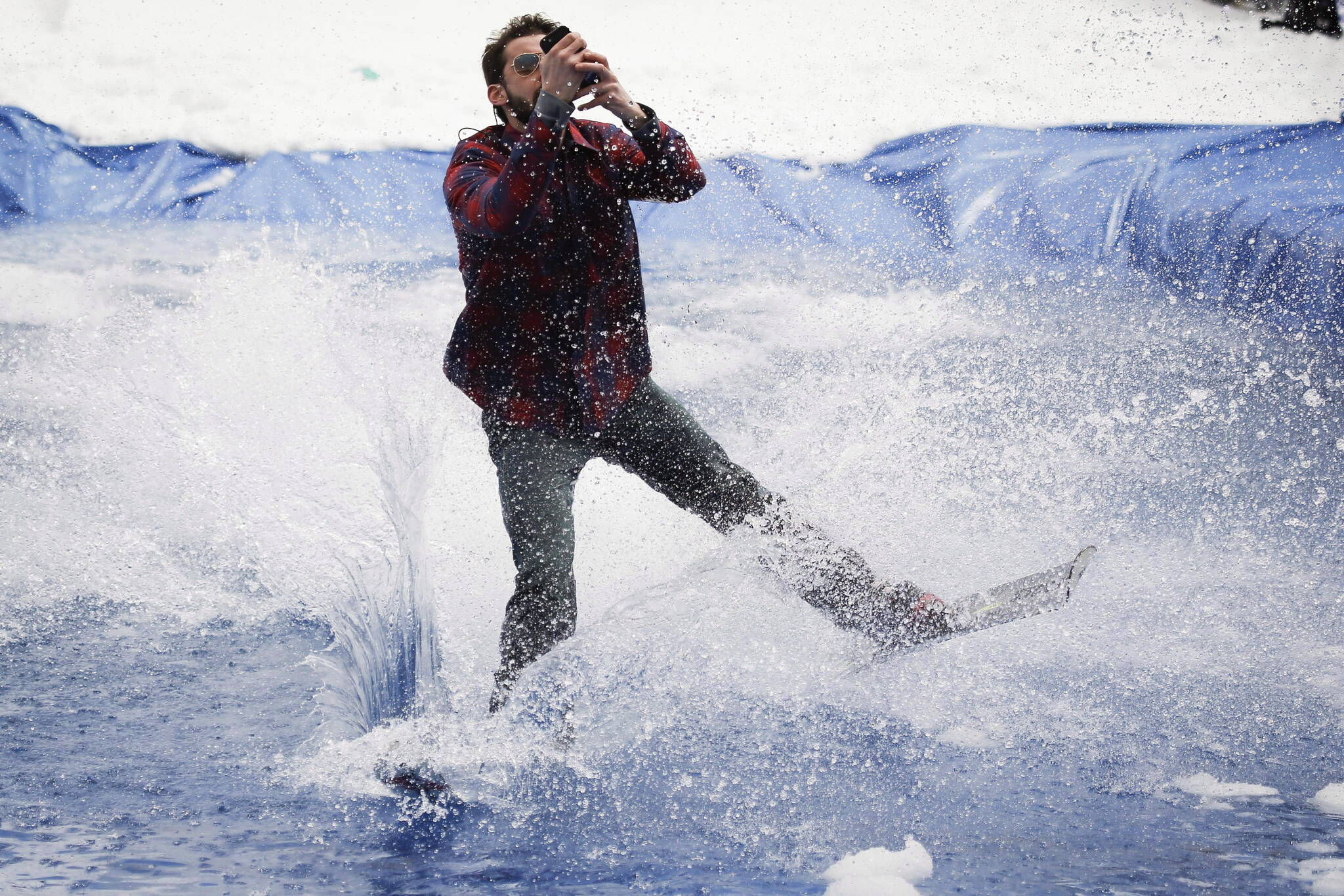 Devon Wheeler takes a selfie as he hits the water during the “Slush Cup” at Sunshine Village ski resort near Banff, Alta., Monday, May 19, 2014. This is the 86th annual event and features prizes for the best belly flop, biggest splash and best face plant. THE CANADIAN PRESS/Jeff McIntosh