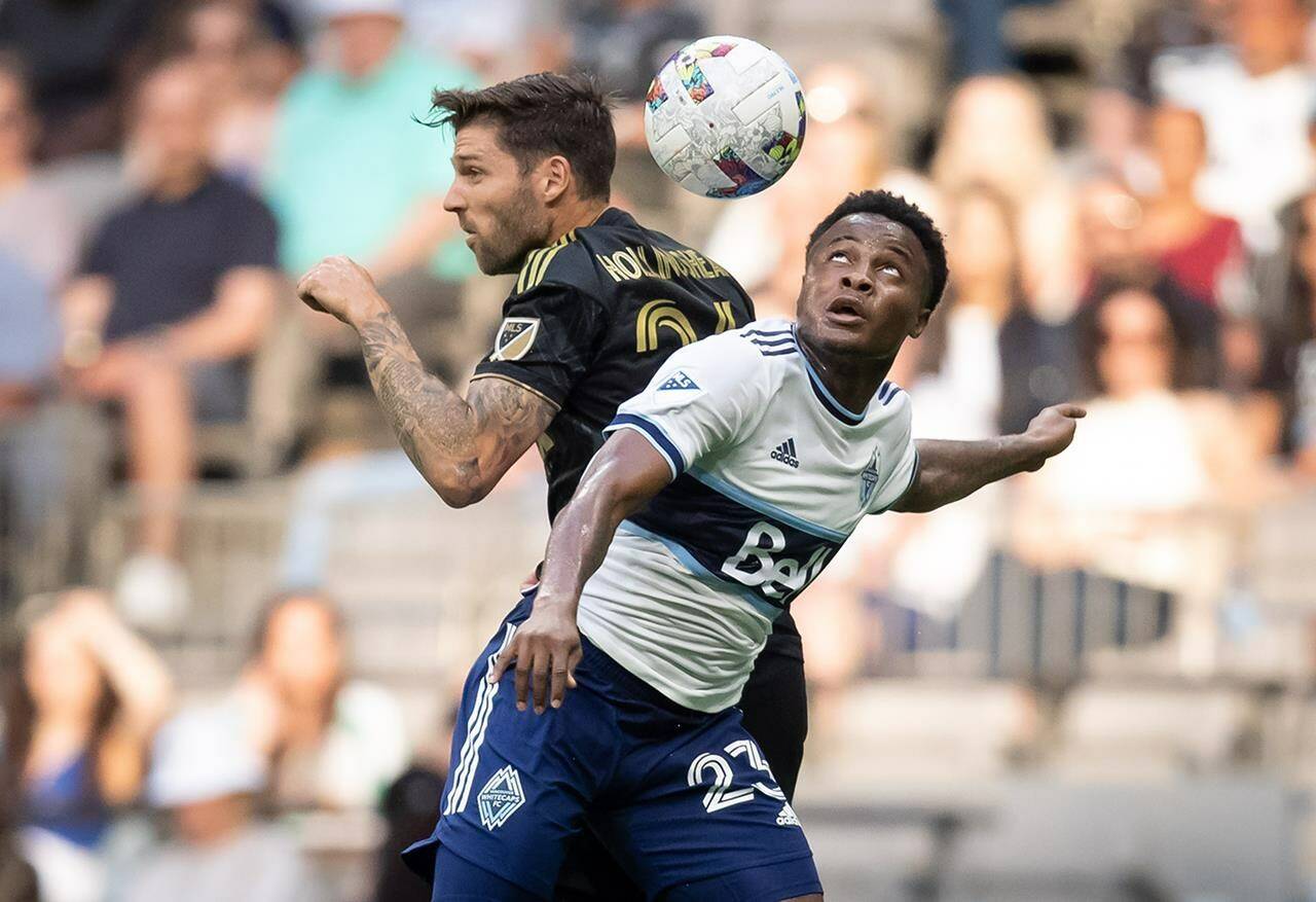 Vancouver Whitecaps’ Javain Brown, front right, and Los Angeles FC’s Ryan Hollingshead vie for the ball during the first half of an MLS soccer game in Vancouver, on Saturday, July 2, 2022. THE CANADIAN PRESS/Darryl Dyck