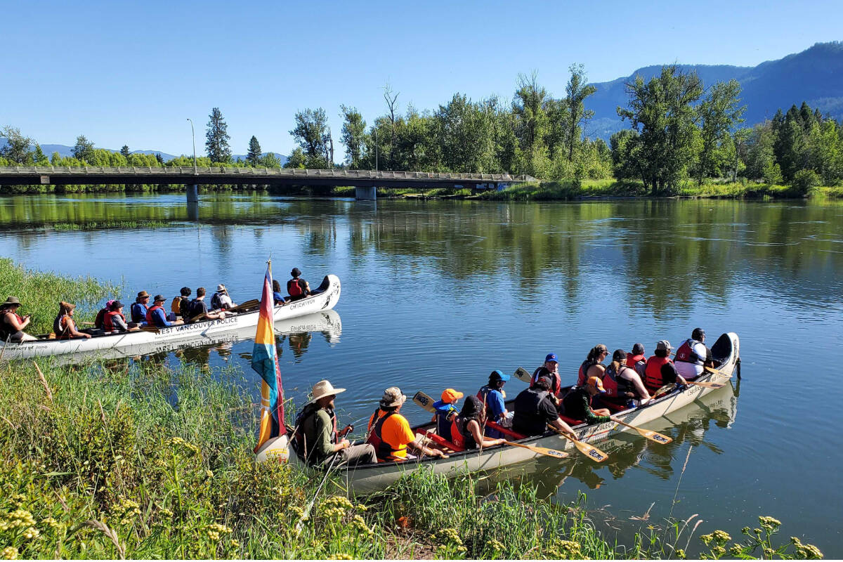 Canoes dot the western shore of the Shuswap River at Belvidere Park in Enderby Tuesday, July 12, for the start of the Pulling Together Canoe Journey. (Roger Knox - Morning Star)