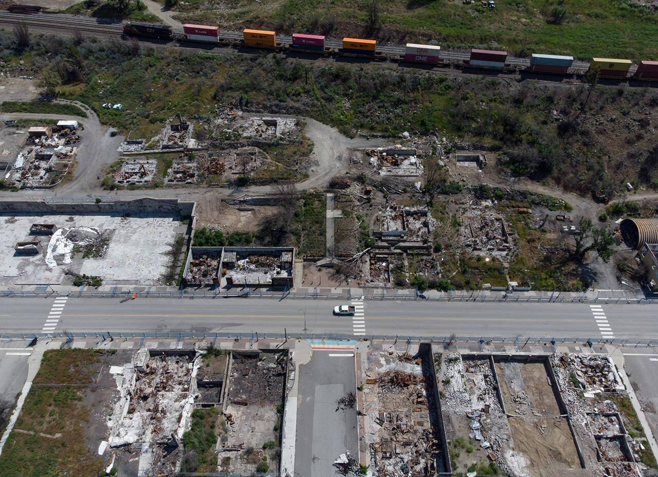 A freight train travels past the remains of houses and businesses destroyed by the 2021 wildfire, in Lytton, B.C., on Wednesday, June 15, 2022. The acting chief of the Lytton First Nation says about 30 evacuees briefly returned home in an effort to salvage food they left behind in freezers when a wildfire broke out Thursday nearly two kilometres northwest of Lytton. CANADIAN PRESS/Darryl Dyck