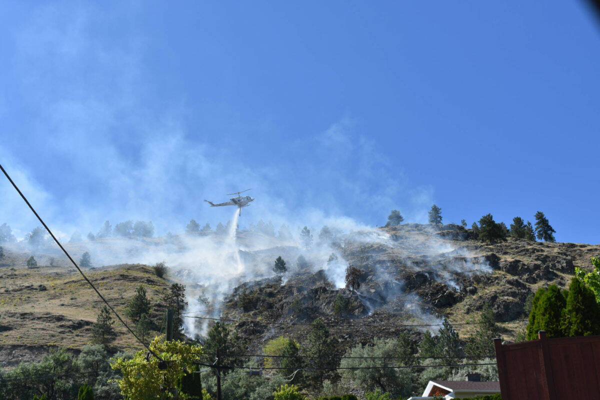 Two BC Wildfire helicopters quickly attacked a growing grass fire above a Sage Mesa neighbourhood. The .75 hectare fire was brought under control by Monday evening. (Monique Tamminga Western News)