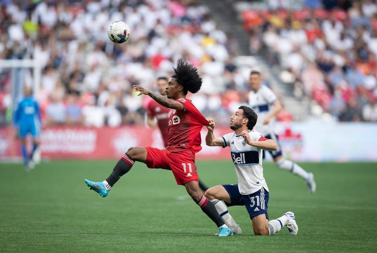 Toronto FC’s Jayden Nelson (11) and Vancouver Whitecaps’ Russell Teibert (31) vie for the ball during the first half of the Canadian Championship soccer final, in Vancouver, on Tuesday, July 26, 2022. THE CANADIAN PRESS/Darryl Dyck