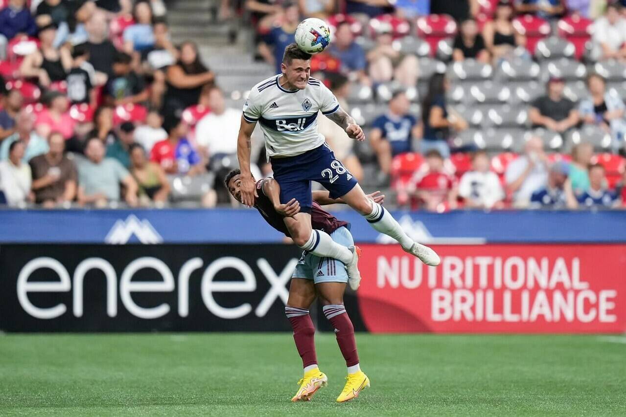Vancouver Whitecaps’ Jake Nerwinski, front, and Colorado Rapids’ Jonathan Lewis vie for the ball during the second half of an MLS soccer game in Vancouver, on Wednesday, August 17, 2022. THE CANADIAN PRESS/Darryl Dyck