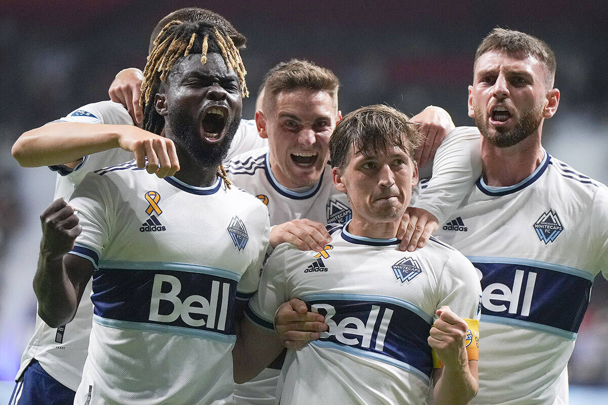 Vancouver Whitecaps’ Leonard Owusu, from left to right, Jake Nerwinski, Ryan Gauld and Tristan Blackmon celebrate Gauld’s goal against the Los Angeles Galaxy during the second half of an MLS soccer game in Vancouver, on Wednesday, September 14, 2022. THE CANADIAN PRESS/Darryl Dyck