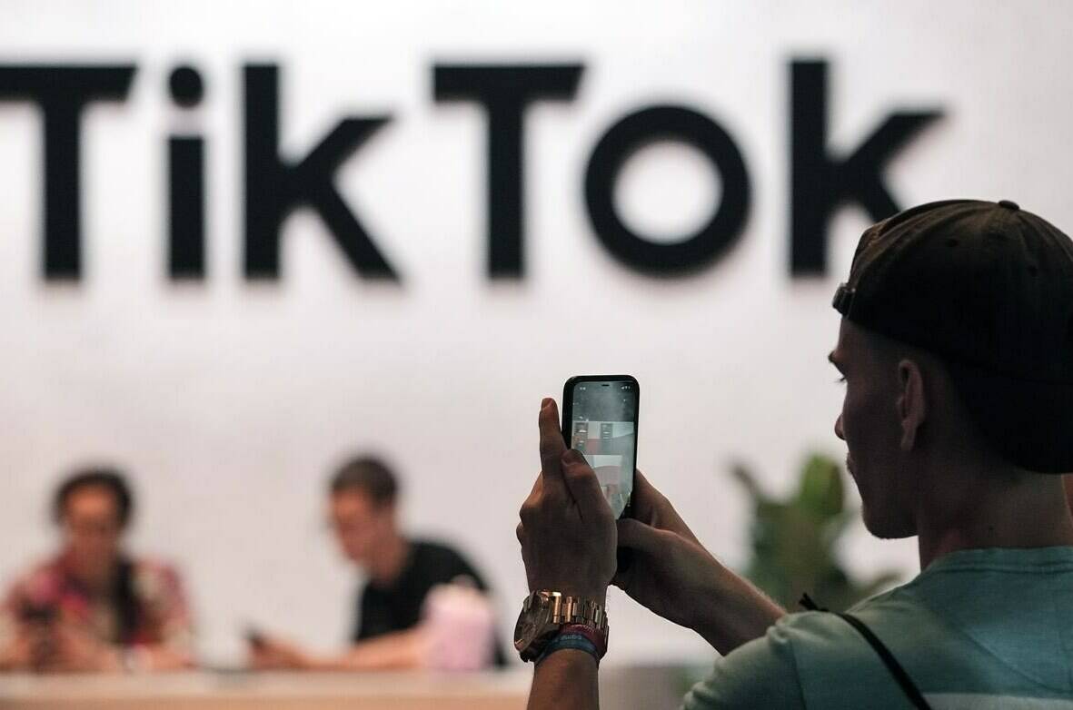 A visitor makes a photo at the TikTok exhibition stands at the Gamescom computer gaming fair in Cologne, Germany, Thursday, Aug. 25, 2022. Online streaming giants YouTube and TikTok are asking Canadian senators to take a sober second look at an online streaming bill that they say would cause significant harm Canadian digital creators. THE CANADIAN PRESS/AP, Martin Meissner