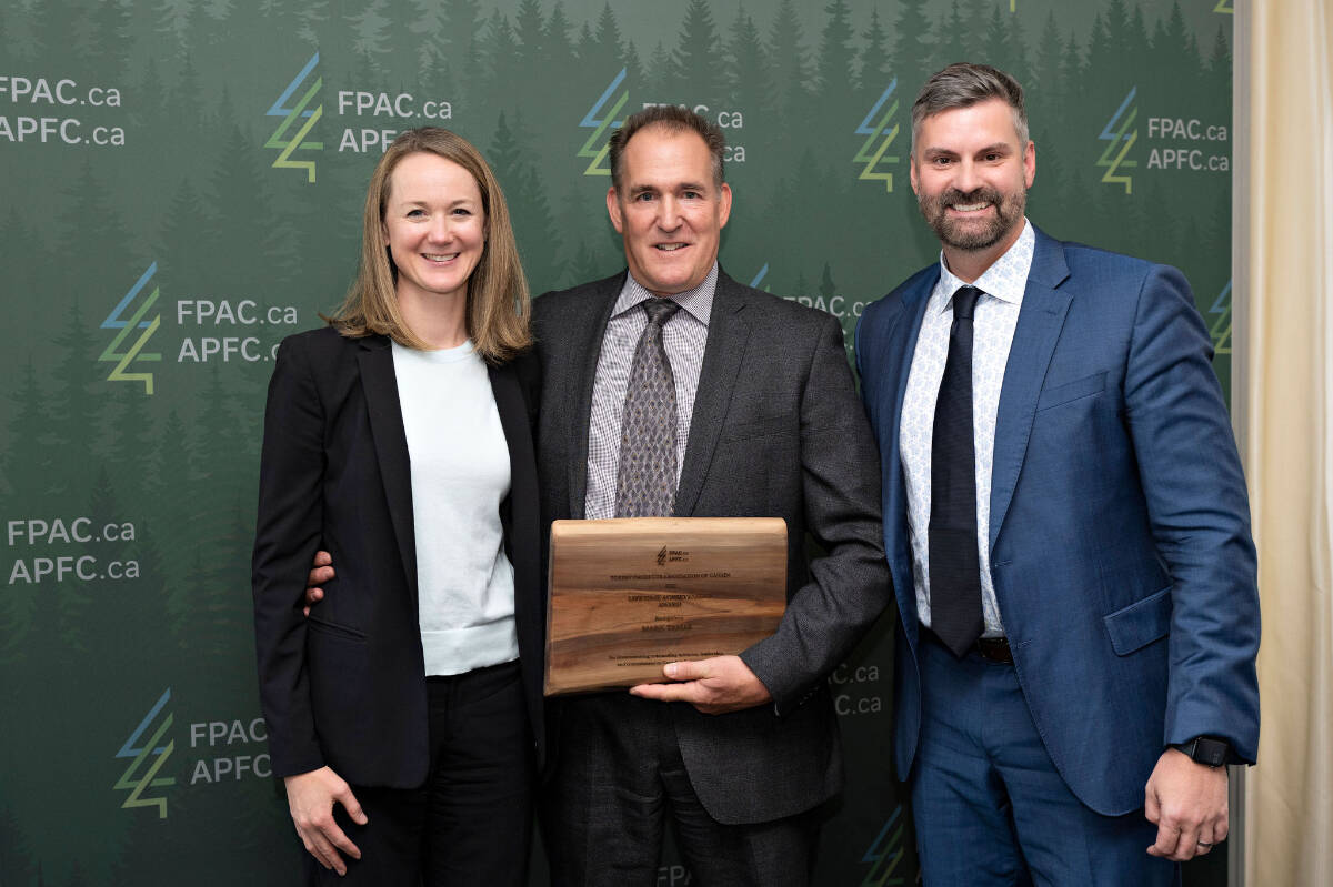 Former Tolko Industries chief forester Mark Tamas (centre) is presented with a Forest Products Association of Canada Lifetime Achievement Award from FPAC’s Kate Lindsay (left) and Derek Nighbor. (Contributed)