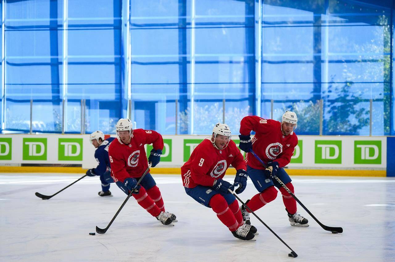 Vancouver Canucks’ Brock Boeser (6), J.T. Miller (9) and Tanner Pearson (70) skate during the NHL hockey team’s training camp in Whistler, B.C., on Thursday, Sept. 22, 2022. The Canucks will start the season without Boeser after the right-winger underwent hand surgery.THE CANADIAN PRESS/Darryl Dyck