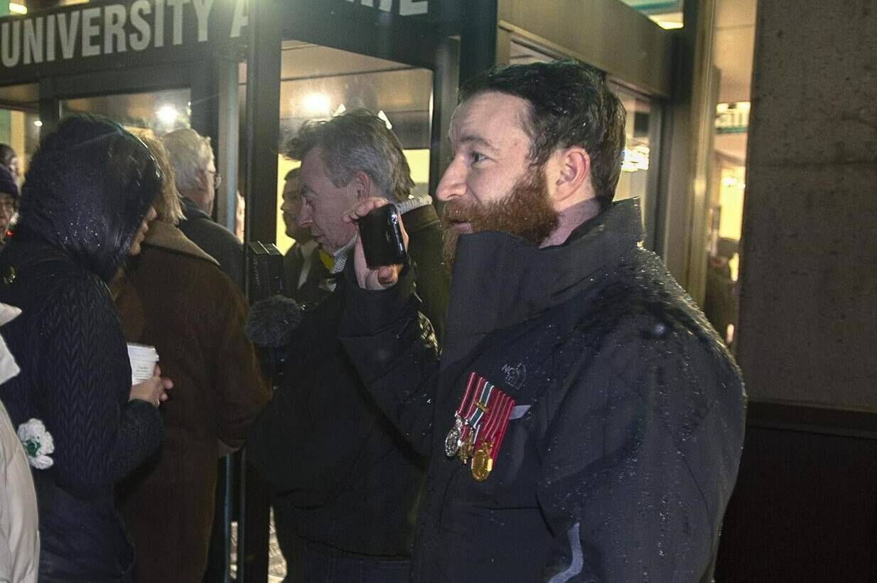 Jeremy MacKenzie, right, a Canadian military veteran who served in Afghanistan, talks with an unidentified woman outside the venue where Omar Khadr, the former child soldier is speaking in Halifax on Monday, Feb. 10, 2020. Conservative Party Leader Pierre Poilievre says he has referred comments made about his wife by MacKenzie, a popular, far-right streamer, to the RCMP.  THE CANADIAN PRESS/Andrew Vaughan