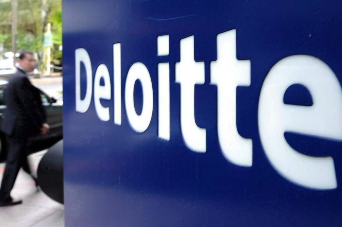 A pedestrian walks past a Deloitte sign in downtown Ottawa on Tuesday, Sept. 20, 2011. A tight labour market and elevated savings during the pandemic will cushion the impact of a recession on Canadians, says a new report from Deloitte. THE CANADIAN PRESS/Sean Kilpatrick