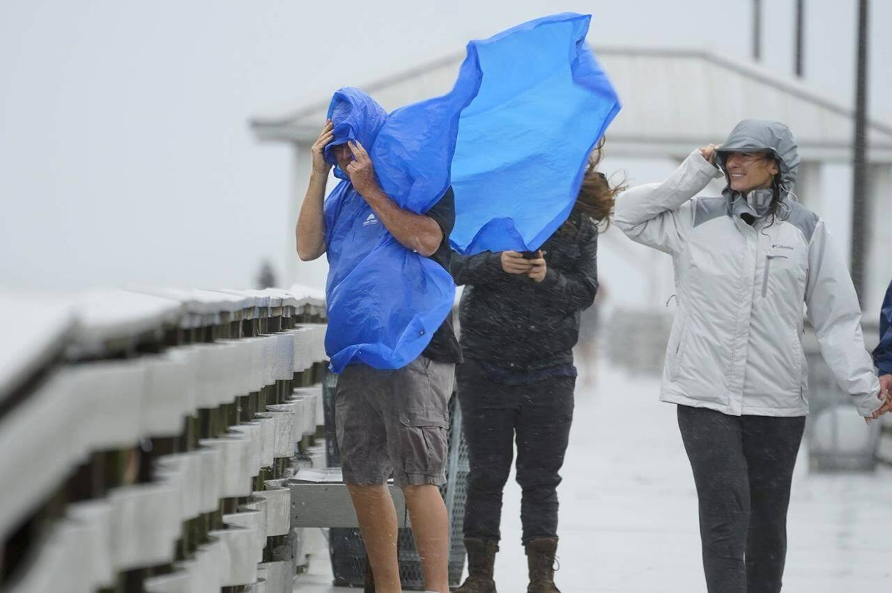 People walk on the Ballast Point Pier ahead of Hurricane Ian, Wednesday, Sept. 28, 2022, in Tampa, Fla. The U.S. National Hurricane Center says Ian’s most damaging winds have begun hitting Florida’s southwest coast as the storm approaches landfall. THE CANADIAN PRESS/AP-Chris O’Meara