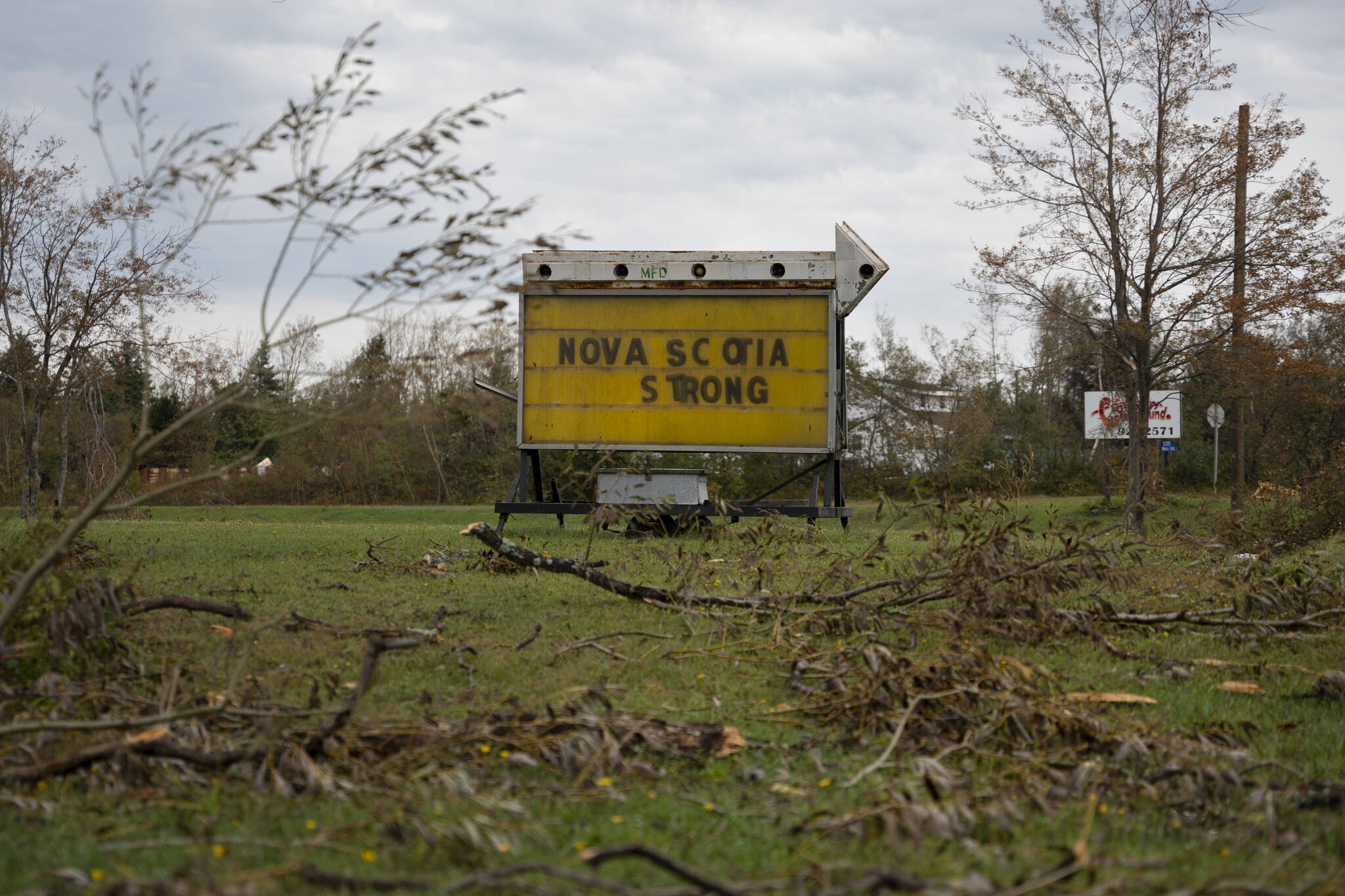 A sign depicting a hopeful message is seen amidst downed tree limbs near Lower Barneys River in Pictou County, N.S. on Wednesday, September 28, 2022 following significant damage brought by post tropical storm Fiona. THE CANADIAN PRESS/Darren Calabrese