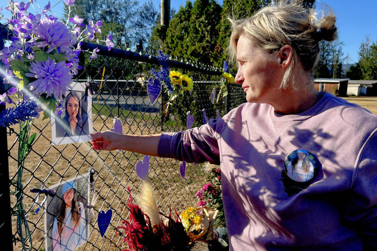 Tara Hartshorne touches a photograph of her daughter Chloe Des Rochers at a memorial at the corner of Ford and Nevin roads in Chilliwack on Sept. 20, 2022. Des Rochers was on a skateboard when she was struck and killed by a pickup truck driver at the intersection on Aug. 1, 2022. (Paul Henderson/ Chilliwack Progress)