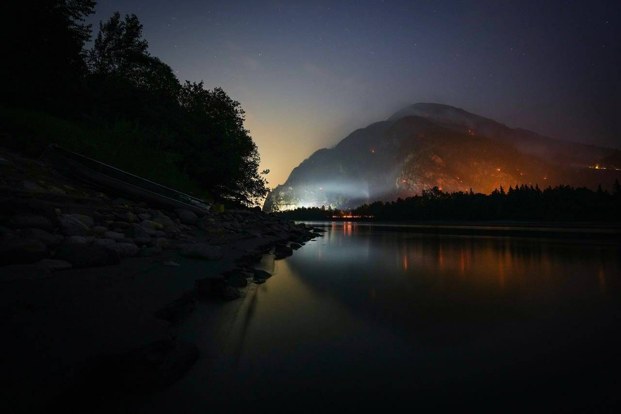 The Flood Falls Trail wildfire burns above the Fraser River in Hope, B.C., Monday, Sept. 12, 2022. As hot and dry conditions persist in the province, the superintendent of BC Wildfire Service’s predictive services unit warns fire season in British Columbia is not yet over. THE CANADIAN PRESS/Darryl Dyck