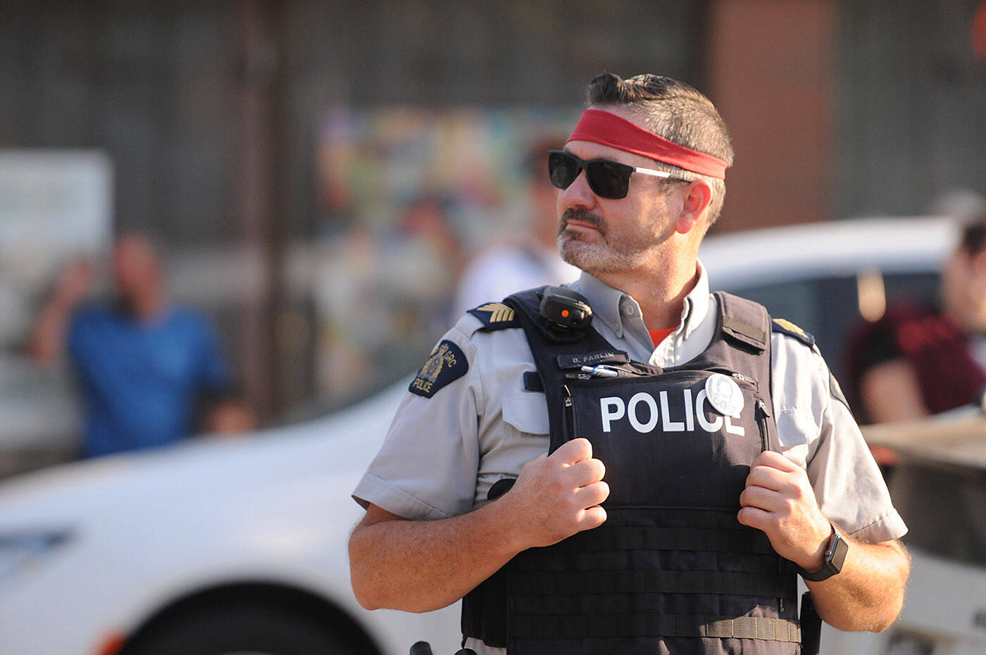 Staff Sgt. Dwayne Farlin with Hope RCMP stands on Wallace Street during the Rambo First Blood 40th Anniversary celebrations in Hope on Saturday, Oct. 8, 2022. (Jenna Hauck/ Black Press Media)