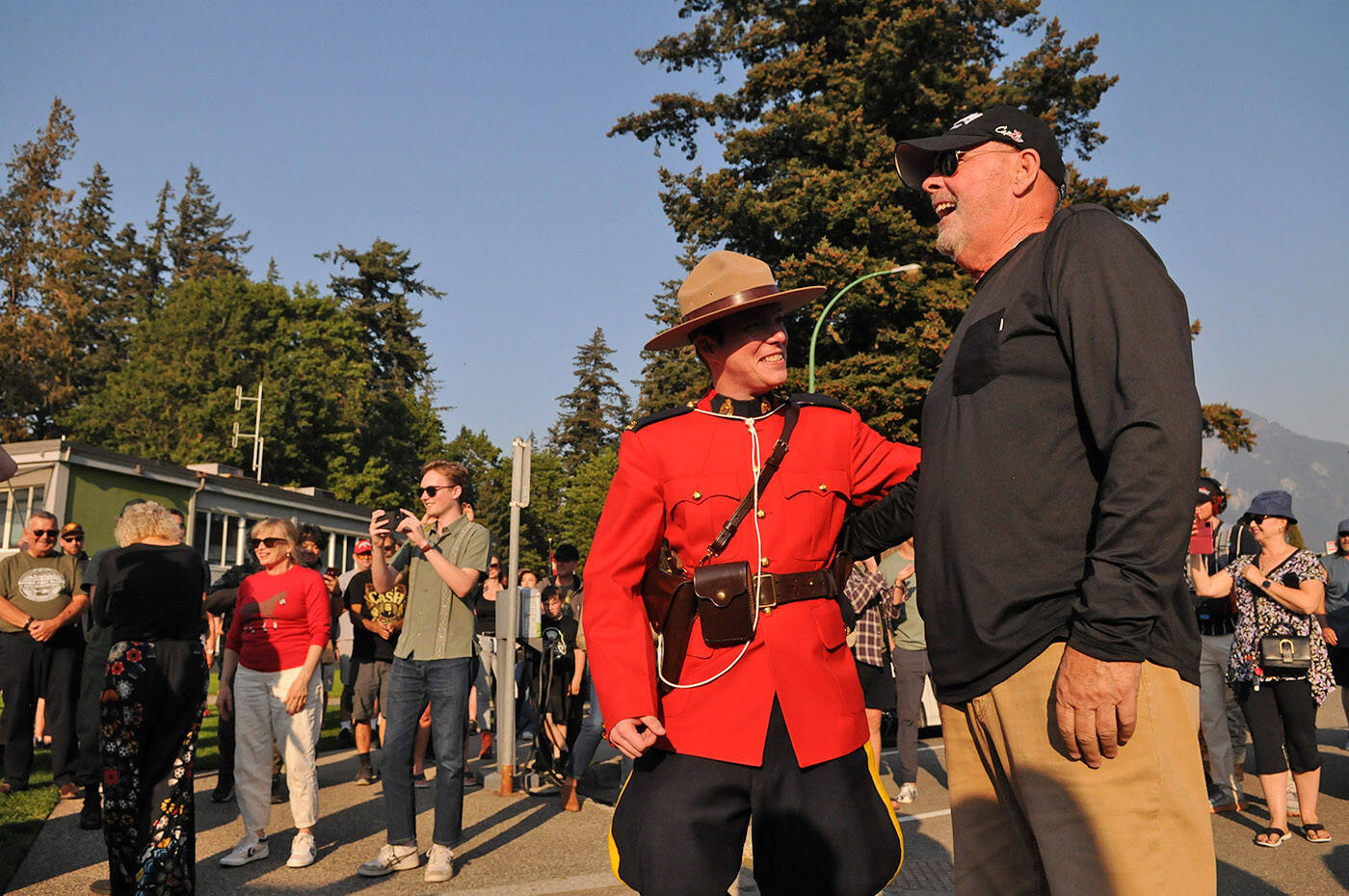 An RCMP officer in red serge chats with actor Patrick Stack who played Lt. Clinton Morgen during the Rambo First Blood 40th Anniversary celebrations in Hope on Saturday, Oct. 8, 2022. (Jenna Hauck/ Black Press Media)