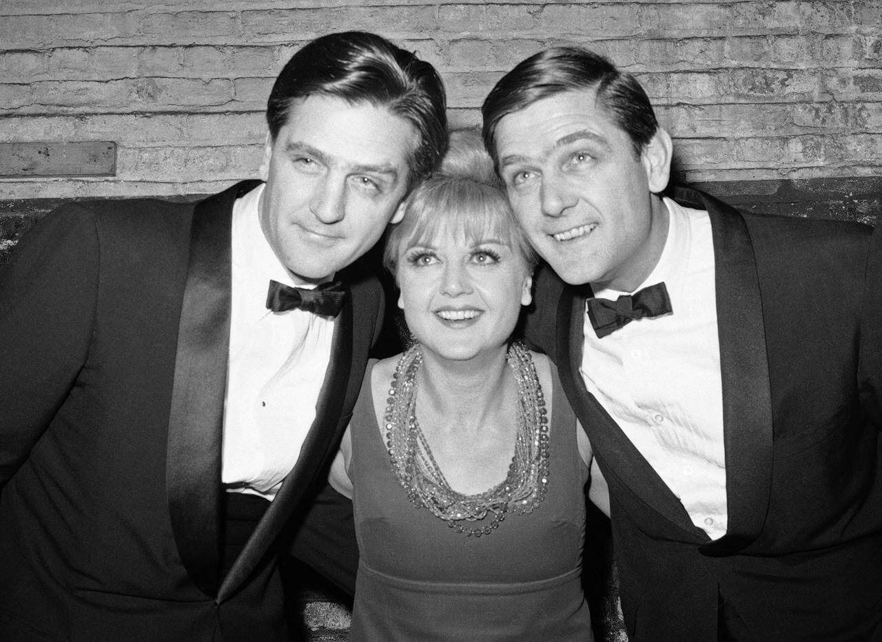 FILE - Angela Lansbury poses with her twin brothers Edgar, left, and Bruce backstage at the Belasco Theatre in New York in February 1966 after premier of “First One Asleep Whistle.” Lansbury, the big-eyed, scene-stealing British actress who kicked up her heels in the Broadway musicals “Mame” and “Gypsy” and solved endless murders as crime novelist Jessica Fletcher in the long-running TV series “Murder, She Wrote,” died peacefully at her home in Los Angeles on Tuesday. She was 96. (AP Photo/Charles Harrity, File)