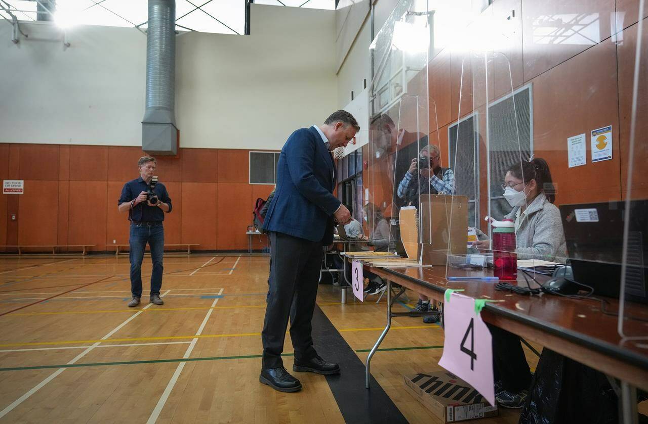 Vancouver mayoral candidate, incumbent Kennedy Stewart, picks up his civic election ballot from a polling station worker as he votes at an advance poll, in Vancouver, B.C., Thursday, Oct. 13, 2022. General local elections are scheduled in British Columbia municipalities Saturday. THE CANADIAN PRESS/Darryl Dyck