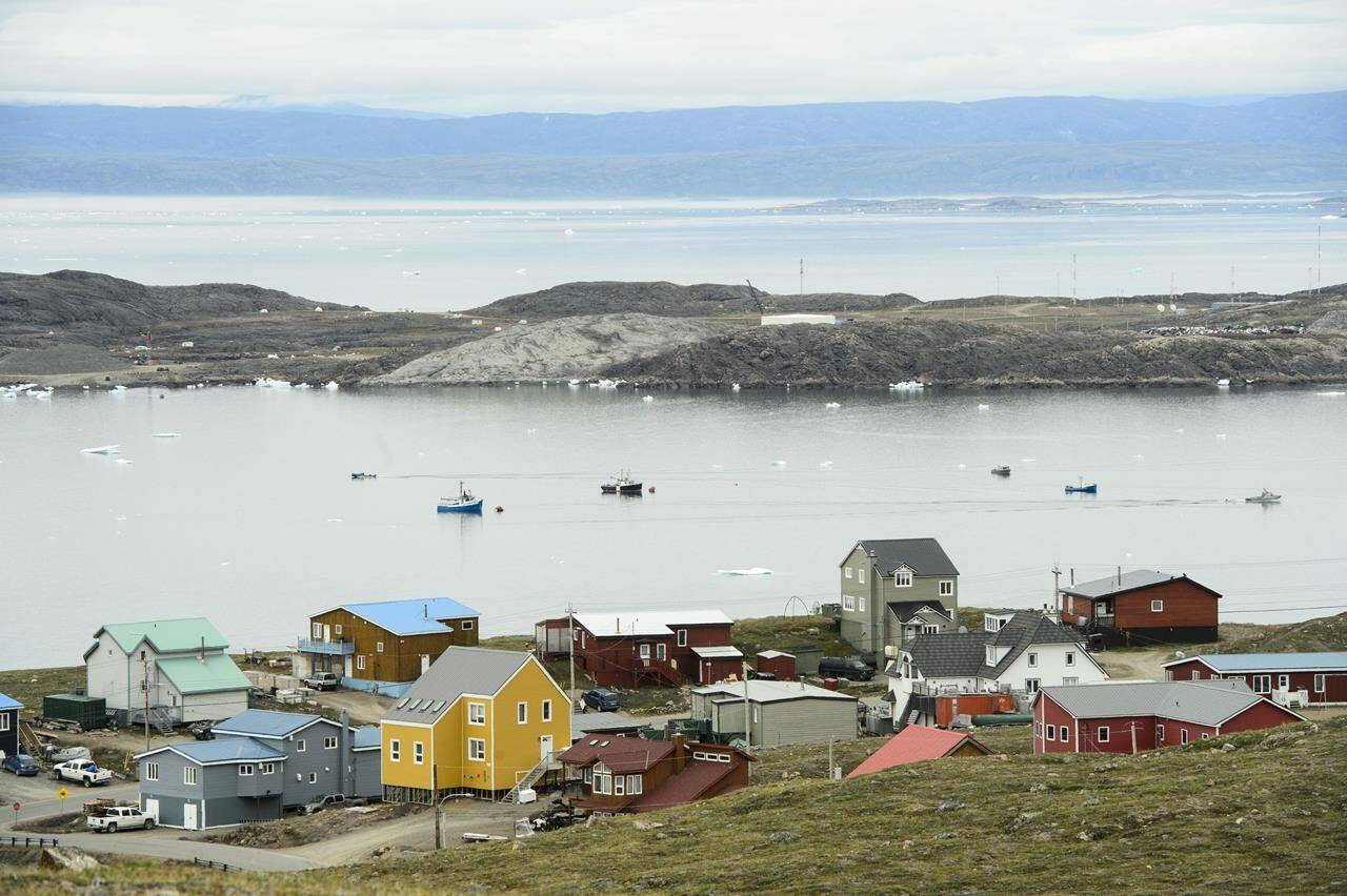 Small boats make their way through the Frobisher Bay inlet in Iqaluit on Friday, Aug. 2, 2019. THE CANADIAN PRESS/Sean Kilpatrick