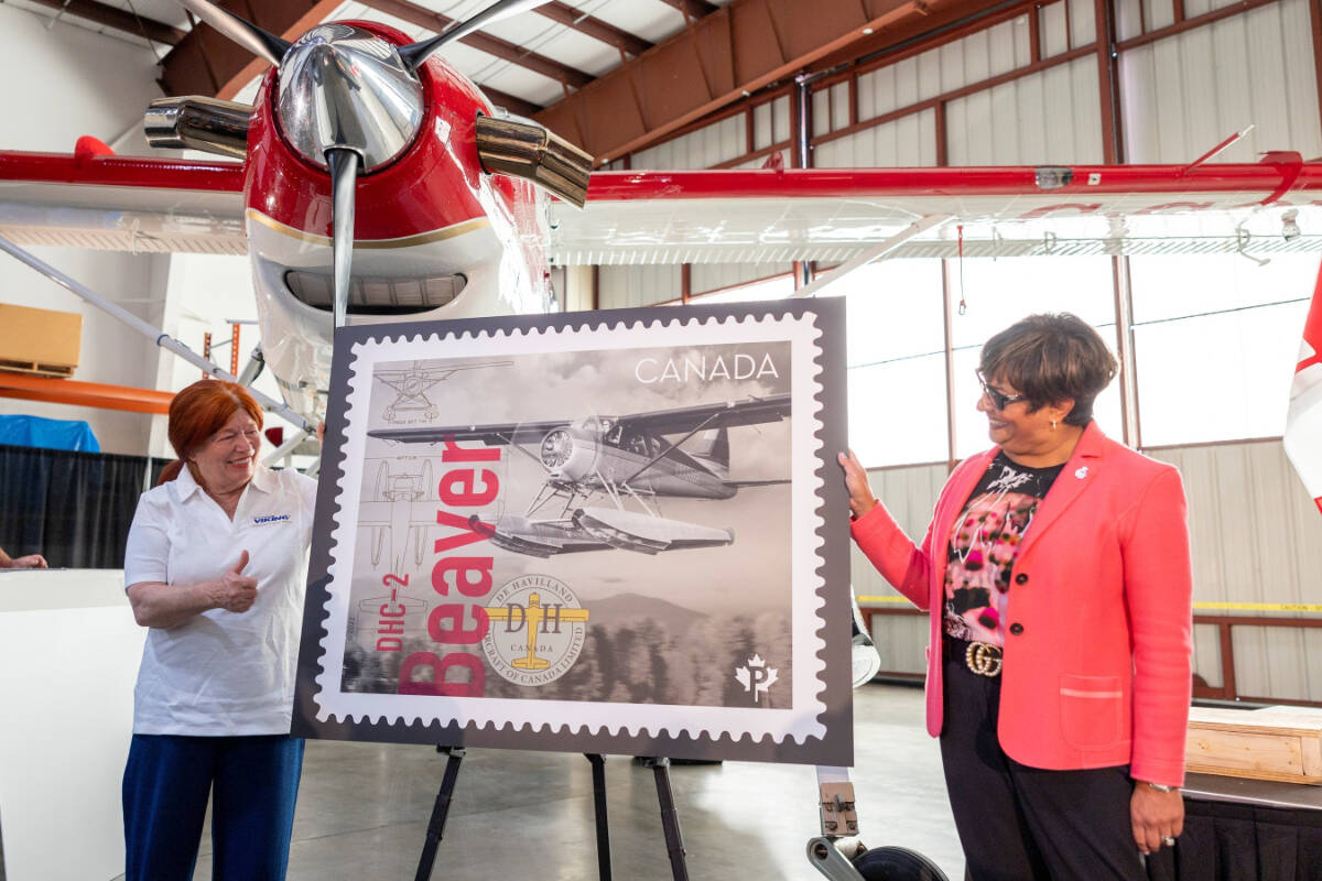 Sherry Brydson, owner of De Havilland Canada and Suromitra Sanatani, Canada Post’s chair of the board of directors, unveil the DHC-2 Beaver postage stamp at Viking Air Ltd. (Courtesy of CNW Group/De Havilland Aircraft of Canada)