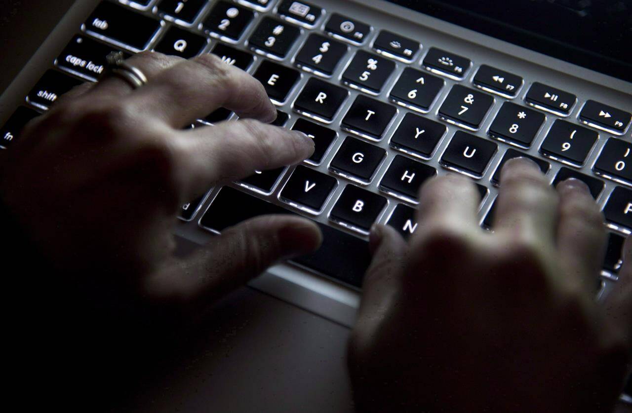 Hands type on a keyboard in North Vancouver, B.C., on Wednesday, December, 19, 2012. A new research report says federal cybersecurity legislation is so flawed it would allow authoritarian governments around the world to justify their own repressive laws.THE CANADIAN PRESS/Jonathan Hayward