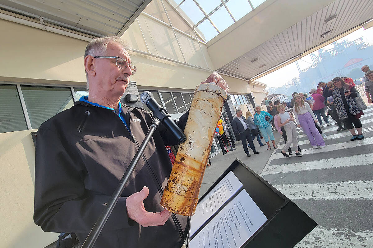 Otter Co-op board of directors president Charlie Fox wrestled with a time capsule from the 1980’s on Wednesday, Oct. 19, as the Langley retail centre celebrated its 100th anniversary. (Dan Ferguson/Langley Advance Times)