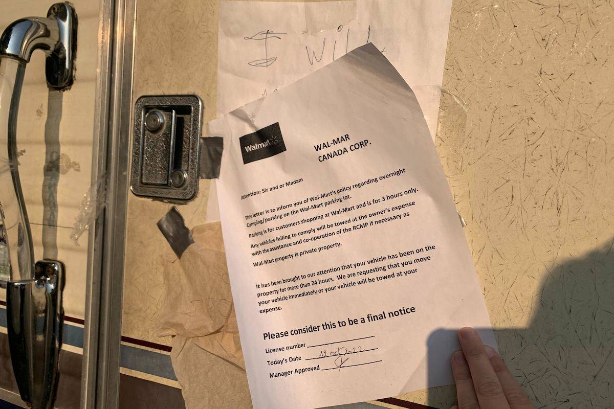A letter from Walmart Corporate posted to the door of a camper parked in the Walmart Kelowna parking lot Oct. 18, 2022 (Brittany Webster - Capital News)