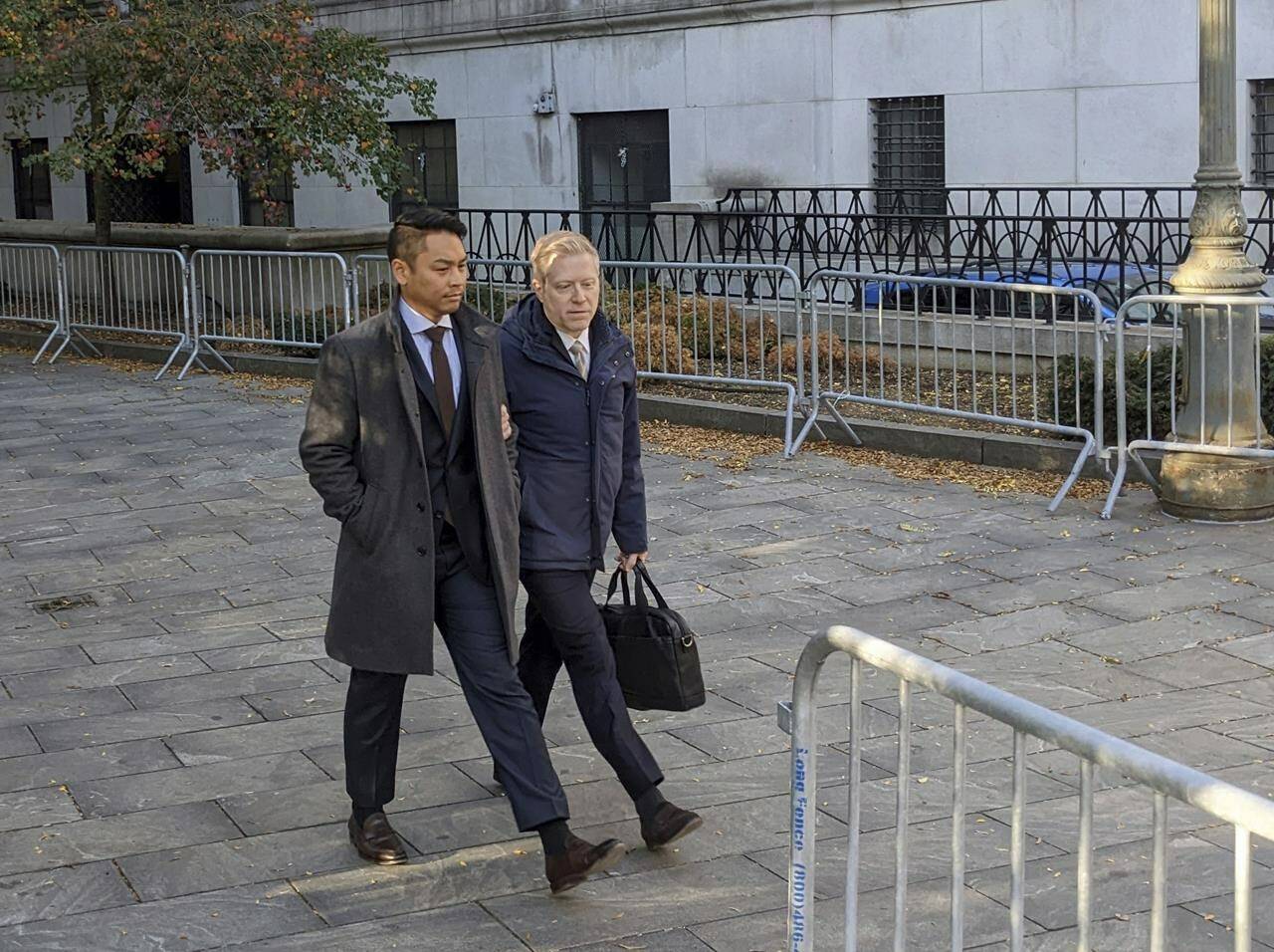 Actor Anthony Rapp, right, and Ken Ithiphol arrive at a federal courthouse in lower Manhattan in New York on Thursday, Oct. 20, 2022, for a civil case against actor Kevin Spacey. (AP Photo/Ted Shaffrey)