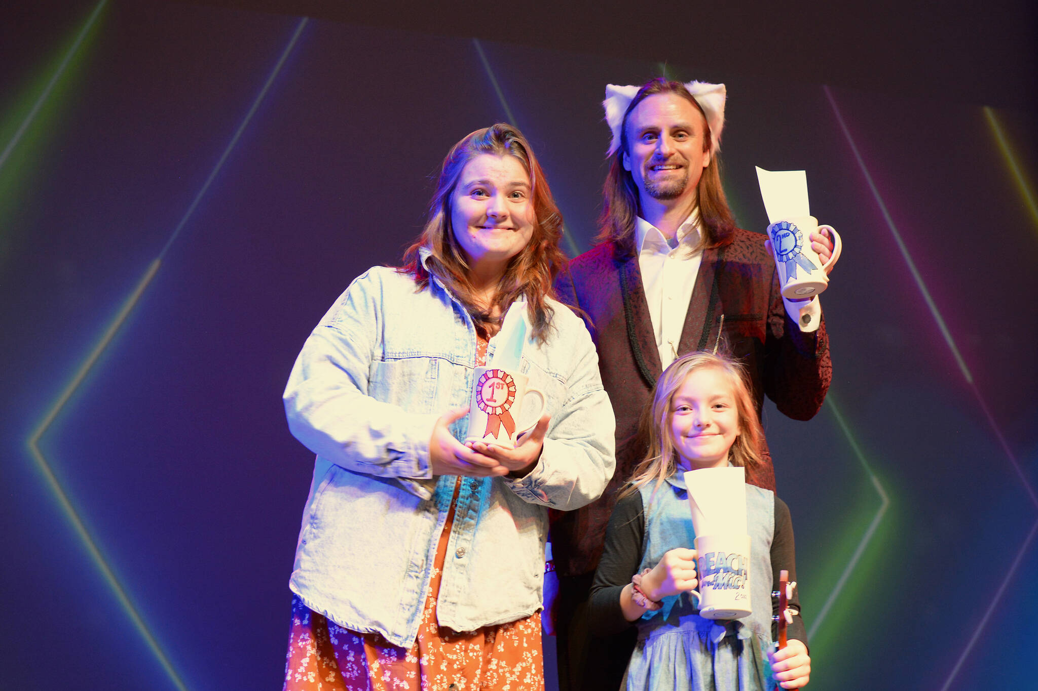 Reach for the Mic winners Zavenda Blackmore, Matty Turner, and Hillaree Blackmore pose together on stage after the competition on Oct. 28. (Photo by Kelsey Yates)