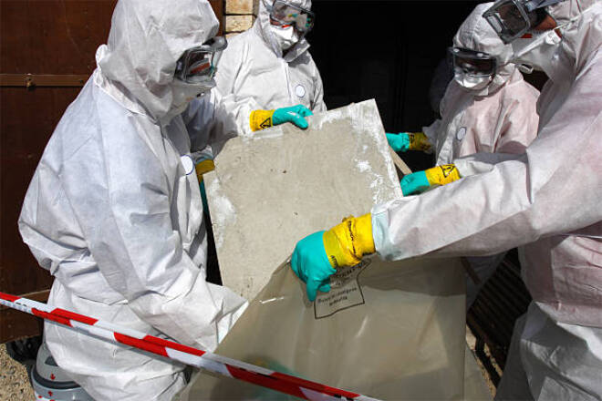 Protected workers remove building remnants containing asbestos. (Contributed)