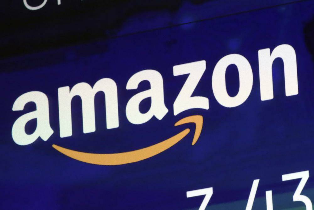 FILE - The Amazon logo is displayed on a screen at the Nasdaq MarketSite, July 27, 2018. Amazon is stepping back into virtual care with a new service that uses secure messaging to connect patients with doctors for help with nearly two dozen conditions. The retail giant said Tuesday, Nov. 15, 2022, it will launch Amazon Clinic in 32 states to provide medication refills and care for conditions like allergies, erectile disfunction, hair loss, and urinary tract infections. (AP Photo/Richard Drew, File)