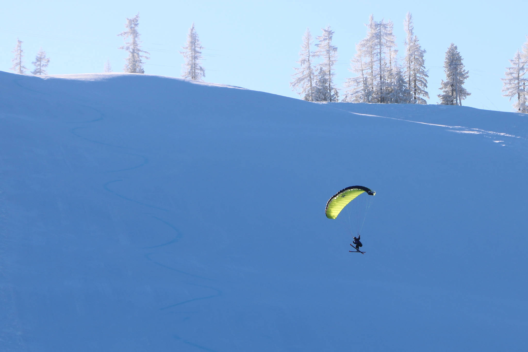 This “kite” skier floated through the air with the greatest of ease up at Red Mountain on a beautiful sunny day last week. Greater Trail municipalities are reminding residents to stay and play local. Photo: Jim Bailey.