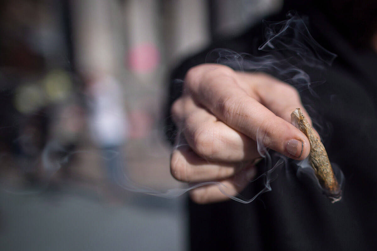 Dasi Menakadasi (not the subject of this article) celebrates by smoking recreational cannabis, in Vancouver on Oct. 17, 2018 on the one-year anniversary of legalization. (THE CANADIAN PRESS file/Darryl Dyck)