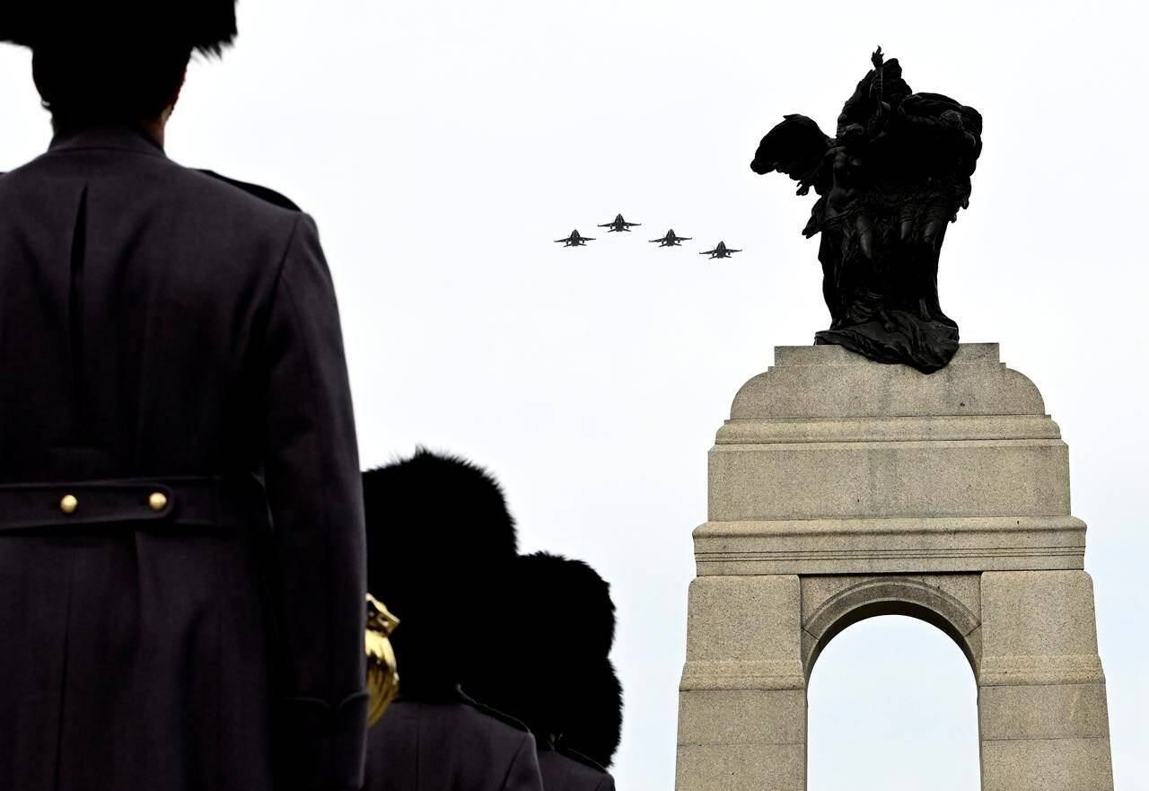 CF-18 Hornets perform a flypast at the National War Memorial during the National Remembrance Day Ceremony in Ottawa, on Friday, Nov. 11, 2022. THE CANADIAN PRESS/Justin Tang