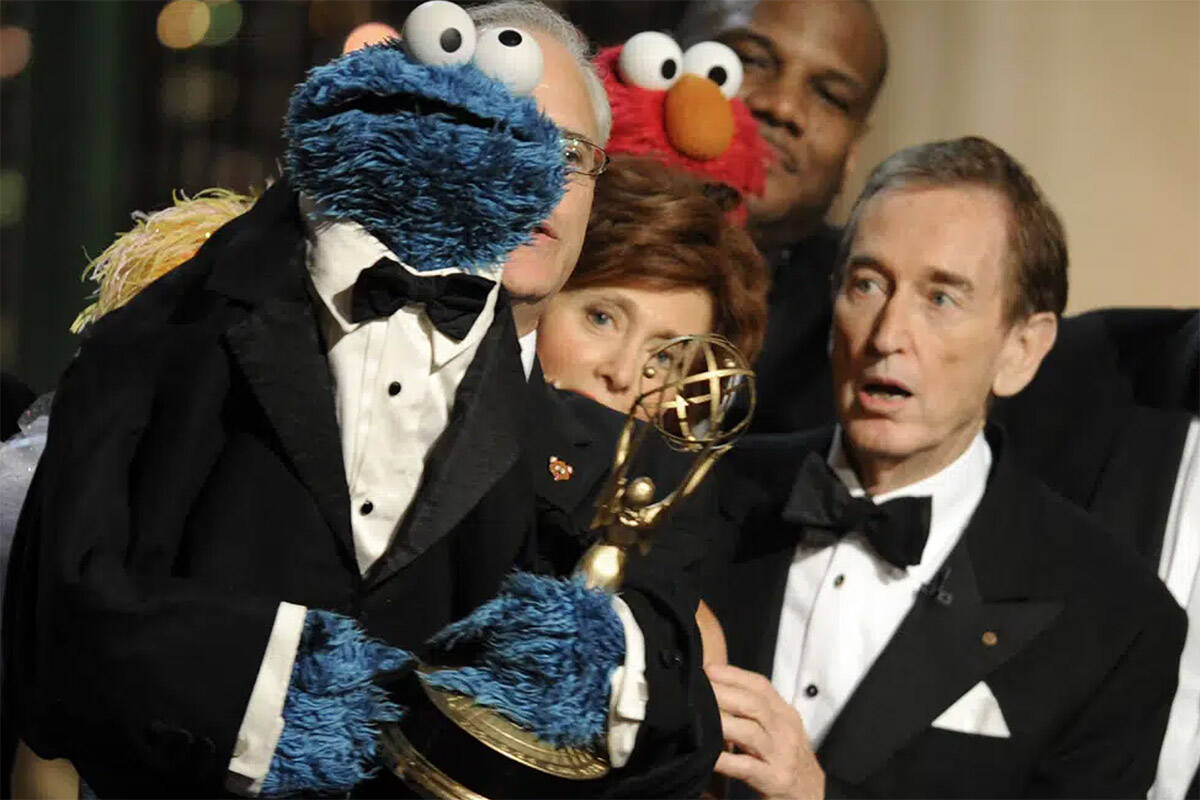 Bob McGrath, right, looks at the Cookie Monster as they accept the Lifetime Achievement Award for ‘Sesame Street’ at the Daytime Emmy Awards on Aug. 30, 2009, in Los Angeles. McGrath, an actor, musician and children’s author widely known for his portrayal of one of the first regular characters on the children’s show ‘Sesame Street’ has died at the age of 90. McGrath’s passing was confirmed by his family who posted on his Facebook page on Sunday, Dec. 4, 2022. (AP Photo/Chris Pizzello, File)