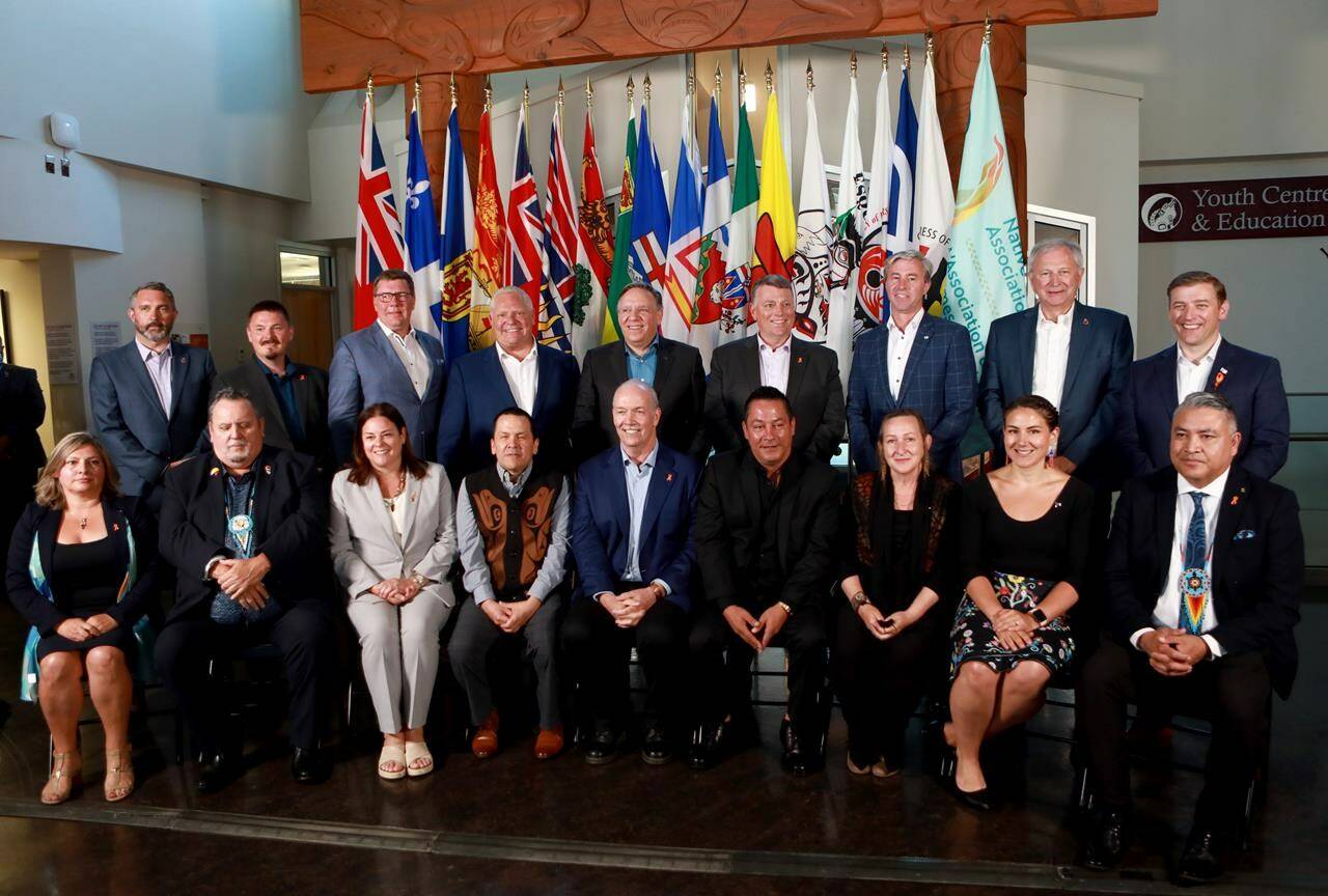 Premiers (back row L-R), Sandy Silver (Yukon), P.J. Akeeagok, (Nunavut), Scott Moe (SK), Doug Ford (Ont),Francois Legault (Que), Dennis King (PEI), Tim Houston (NS), Blaine Higgs (NB), Andrew Furey (NL and Labrador) and (front row L-R), President of Institute for the advancement of Aboriginal Women Lisa Weber, National Chief of Congress of Aboriginal Peoples Elmer St. Pierre, Heather Stefanson (MB), Songhees Nation Chief Ron Sam, John Horgan (BC), Esquimalt Nation Chief Rob Thomas, Caroline Cochrane (NWT), Cassidy Caron (Metis National Council) and Terry Teegee (Assembly of First Nations) gather for a family photo during the summer meeting of the Canada’s Premiers at the Songhees Wellness Centre in Victoria, B.C., on Monday, July 11, 2022. THE CANADIAN PRESS/Chad Hipolito