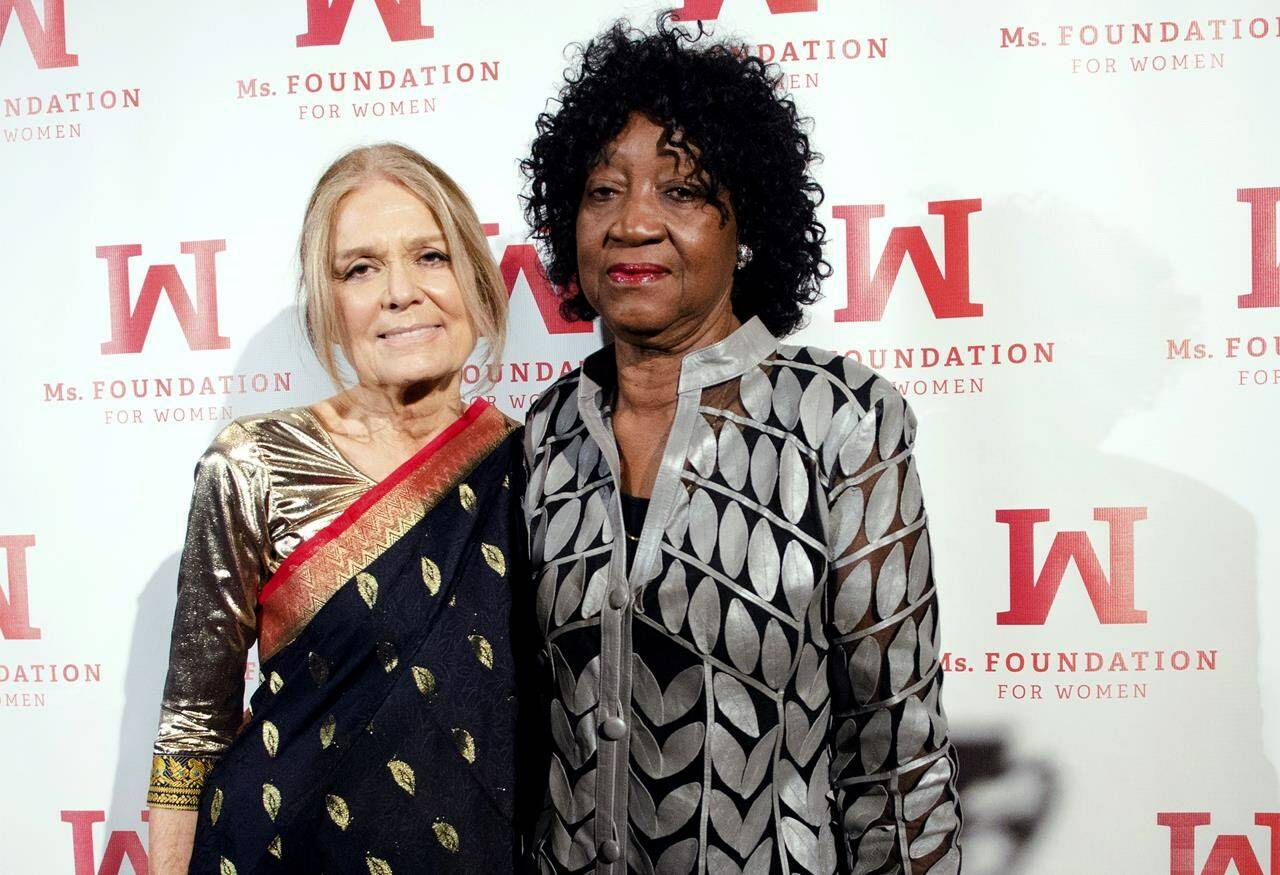 FILE - Gloria Steinem and Dorothy Pitman Hughes attend the Ms. Foundation for Women Gloria Awards at Cipriani 42nd Street in New York, May 1, 2014. Hughes, a pioneering Black feminist, child welfare advocate and activist who co-founded Ms. Magazine with Steinem, formed a powerful speaking partnership with her and appeared with her in one of the most iconic photos of the feminist movement, has died. Hughes died Dec. 1, 2022, in Tampa, Fla. She was 84. (Photo by Scott Roth/Invision/AP, File)