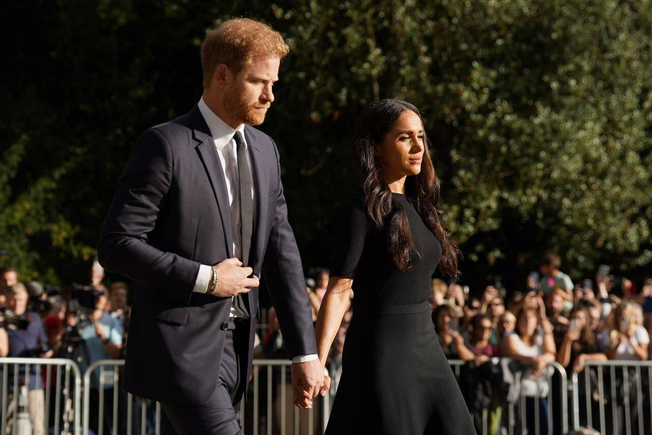 FILE _ Meghan, Duchess of Sussex and Prince Harry meet members of the public at Windsor Castle, following the death of Queen Elizabeth II on Thursday, in Windsor, England, Saturday, Sept. 10, 2022. Prince Harry and his wife, Meghan, are expected to vent their grievances against the monarchy when Netflix releases the final episodes of a series about the couple’s decision to step away from royal duties and make a new start in America. (Kirsty O’Connor/Pool Photo via AP, File)
